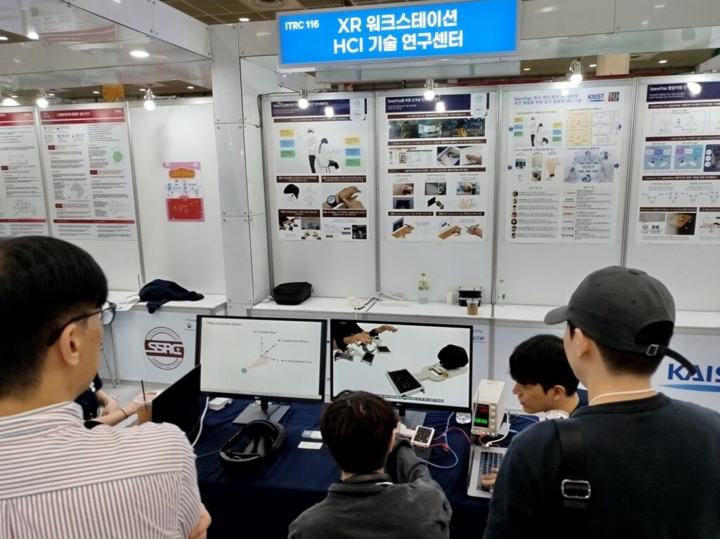 On-site photo of the center booth with a demo at the forum